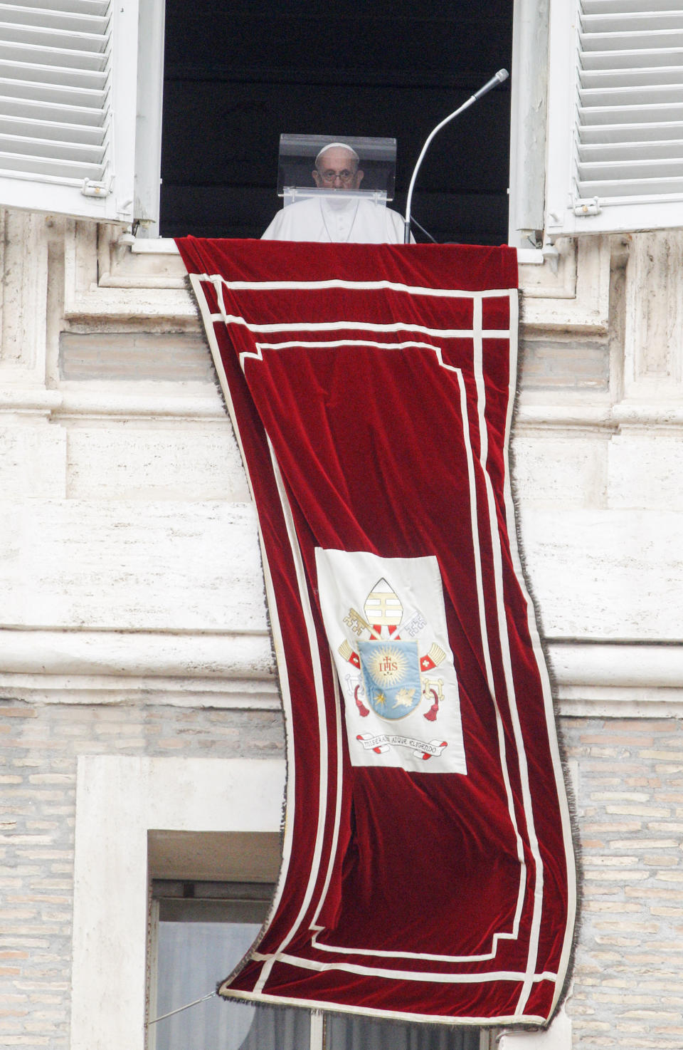 Pope Francis looks from his studio window overlooking St. Peter's Square to celebrate the Angelus prayer, at the Vatican, Sunday, July 25, 2021. Pope Francis has offered his blessing for the Tokyo Olympic Games from Vatican City. Francis told the faithful gathered in St. Peter’s Square for the traditional papal blessing that “in this period of pandemic, these Games are a sign of hope, a sign of universal brotherhood and of a healthy competitive spirit.” (AP Photo/Riccardo De Luca)