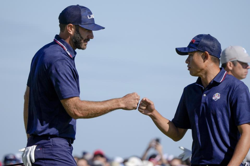 Team USA's Dustin Johnson and Team USA's Collin Morikawa celebrate on the 15th hole during a foursomes match the Ryder Cup at the Whistling Straits Golf Course Saturday, Sept. 25, 2021, in Sheboygan, Wis. (AP Photo/Charlie Neibergall)