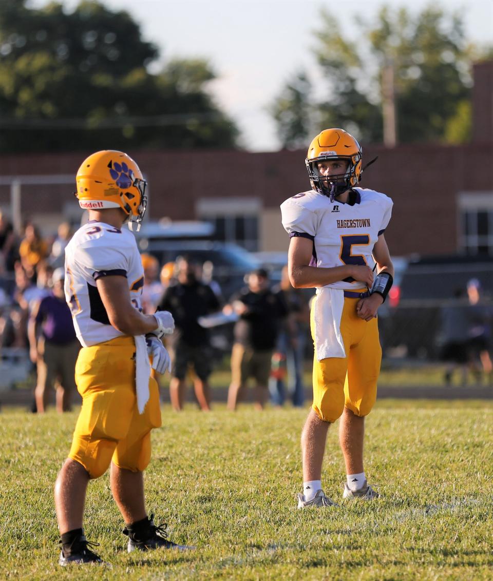 Hagerstown junior Kayne Ervin (right) talks to sophomore Aiden Grover (left) during a game against Centerville Aug. 26, 2022.