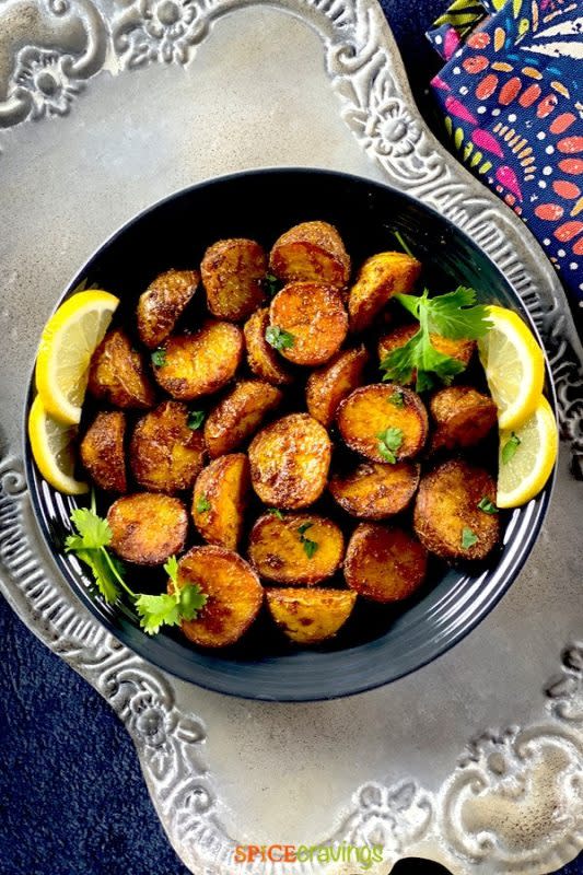 <p>Spice Cravings</p><p>Baby potatoes coated with a potpourri of Indian spices, and cooked till they are golden crisp, these Spicy Bombay Potatoes make for a finger-licking good appetizer, and are a perfect sidekick to any curry or roasted entree.</p><p><strong>Get the recipe here: <a href="https://spicecravings.com/bombay-potatoes" rel="nofollow noopener" target="_blank" data-ylk="slk:Spicy Bombay Potatoes;elm:context_link;itc:0;sec:content-canvas" class="link ">Spicy Bombay Potatoes</a></strong></p><p><strong>Related: <a href="https://parade.com/1207085/kavitharamaswamy/south-indian-food-recipes/" rel="nofollow noopener" target="_blank" data-ylk="slk:25 Vegetarian South Indian Dishes You Need to Try Once;elm:context_link;itc:0;sec:content-canvas" class="link ">25 Vegetarian South Indian Dishes You Need to Try Once</a></strong></p>
