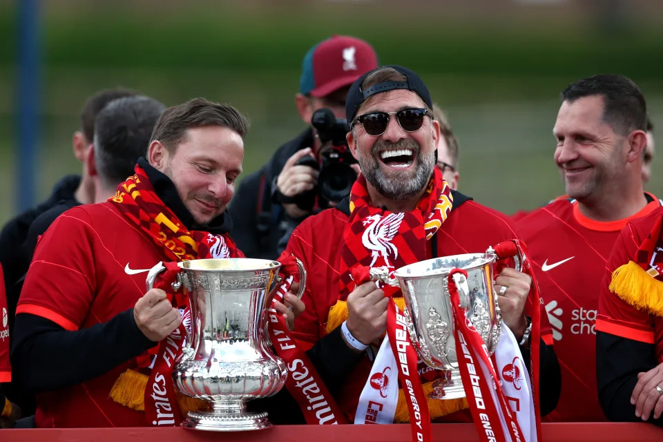 LIVERPOOL, ENGLAND - MAY 29: Pep Lijnders, Assistant Manager and Jurgen Klopp, Manager of Liverpool pose with the FA Cup and the Carabao Cup Trophy during the Liverpool Trophy Parade on May 29, 2022 in Liverpool, England. (Photo by Jan Kruger/Getty Images)