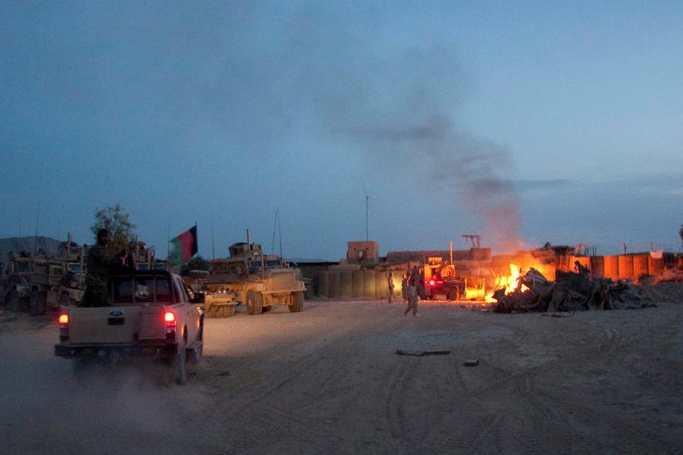 Trash is burned in a pit at Forward Operating Base Caferetta Nawzad in Helmand province, south of Kabul, Afghanistan, on April 28, 2011.