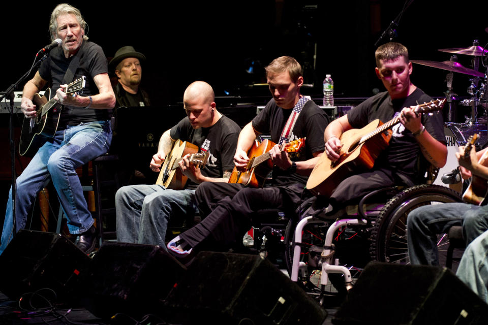 Roger Waters, left, performs with injured service members at the 6th Annual Stand Up For Heroes benefit concert on Thursday, Nov. 8, 2012 in New York. (Photo by Charles Sykes/Invision/AP)