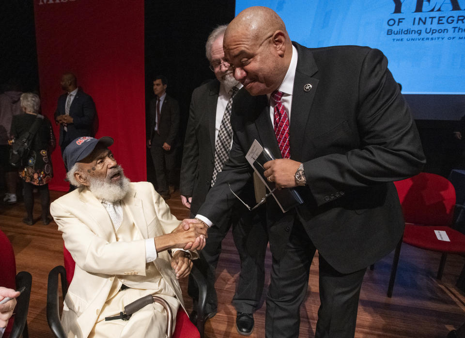 In this photo provided by the University of Mississippi, James Meredith, left, speaks to U.S. Marshals Service Director Ronald L. Davis, Thursday, Sept. 28, 2022, at the University of Mississippi during an event celebrating 60 years of integration. At the event, Davis named Meredith an honorary deputy marshal. In 1962, Meredith became the first Black student to enroll in the university, and federal marshals escorted him onto the campus in Oxford, Miss., as white protesters erupted in violence. (Thomas Graning/University of Mississippi via AP)