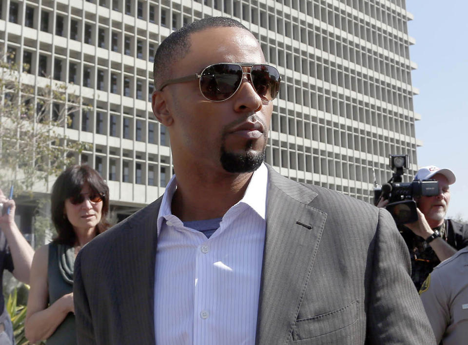 FILE - In this Feb. 14, 2014, file photo, former NFL safety Darren Sharper leaves a courthouse in Los Angeles. Sharper will return to court on Friday March 7, 2014 where his attorneys will argue that the former NFL All-Pro safety should be released from a Los Angeles jail. Sharper has been held without bail because of an arrest warrant issued by Louisiana authorities accusing him and another man of raping two women. (AP Photo/Nick Ut )