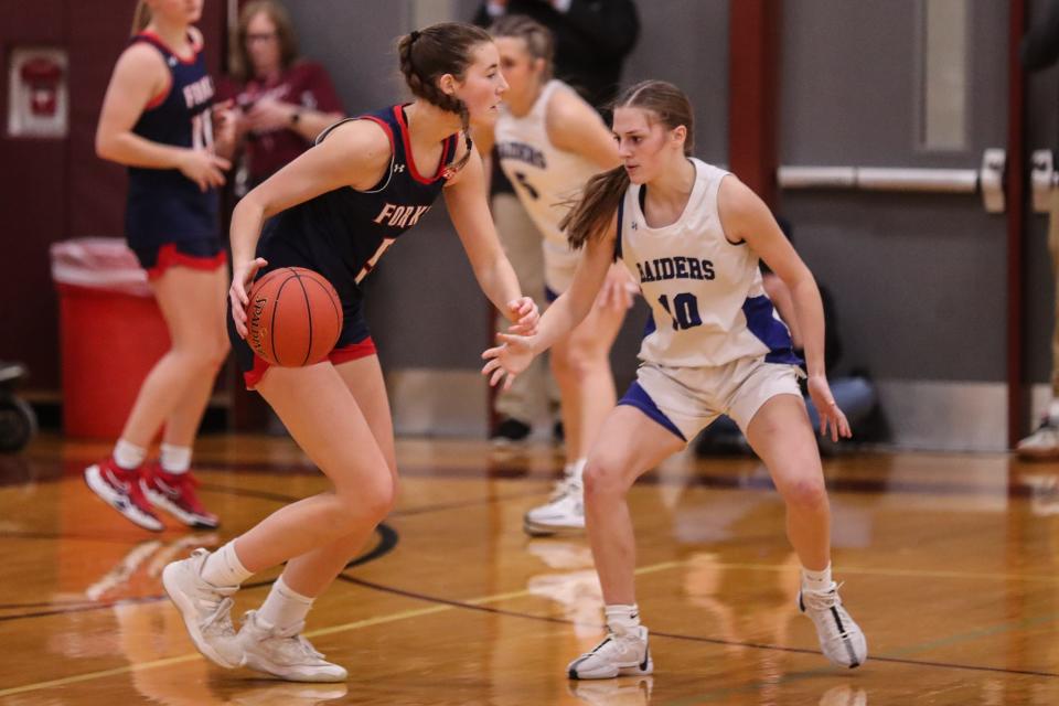 Maggie Warpus from CF tries to find a way around Megan Wolf from Horseheads in the STAC championship game.