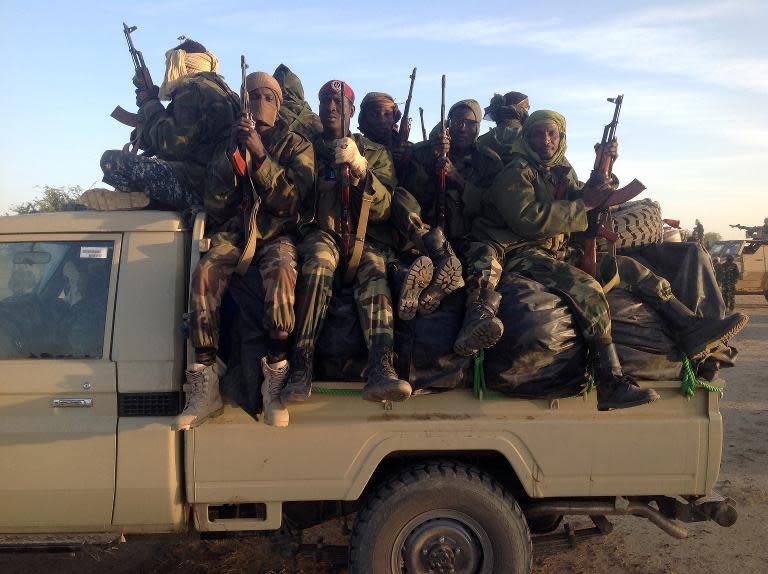 Soldiers of the Chadian army patroling at the border between Nigeria and Cameroon, some 40 km from Maltam, as part of a military contingent against the armed Islamist group Boko Haram, on January 21, 2014