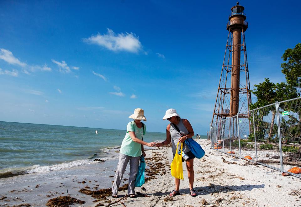 Deborah Parker, from Oklahoma and Dianna Sharum, from Arkansas look for shells at Lighthouse Beach Park on Sanibel Island on Friday, June 16, 2023. The beach reopened Friday after being closed due to damage sustained in Hurricane Ian on Sept. 28 of last year.  