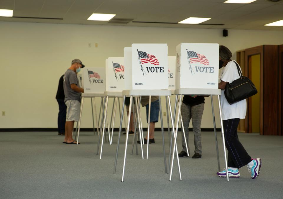 Voters cast ballots in the general election, Friday, Sept. 18, 2020, at the Office of Elections satellite location in Spotsylvania, Va., on the first day of the state's 45-day early voting period.