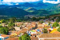 <p>Colorful houses stand in a valley below the Escambray mountains of Trinidad, Cuba // Date unknown</p>