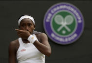 United States' Cori "Coco" Gauff wipes her face during a women's singles match against Romania's Simona Halep on day seven of the Wimbledon Tennis Championships in London, Monday, July 8, 2019. (AP Photo/Kirsty Wigglesworth)