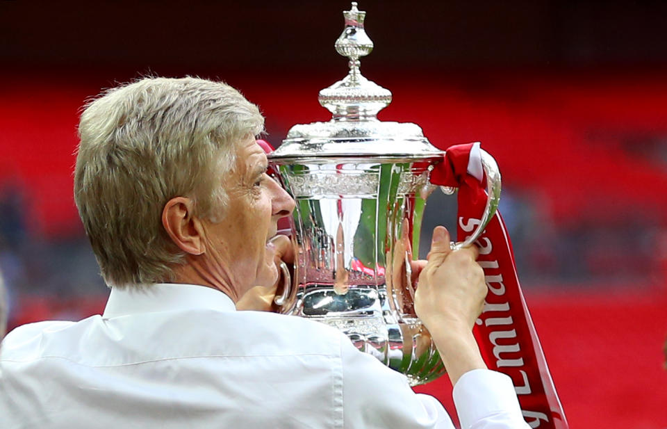 Arsene Wenger, manager of Arsenal with the trophy during the Emirates FA Cup Final match between Arsenal and Chelsea .