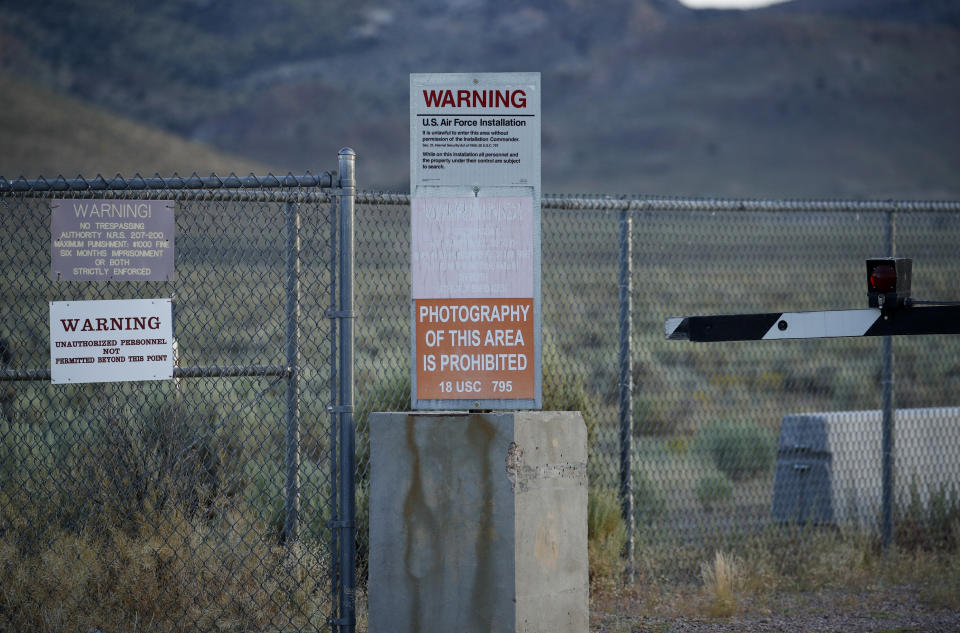 In this July 22, 2019 photo, signs warn about trespassing at an entrance to the Nevada Test and Training Range near Area 51 outside of Rachel, Nev. The U.S. Air Force has warned people against participating in an internet joke suggesting a large crowd of people "storm Area 51," the top-secret Cold War test site in the Nevada desert. (AP Photo/John Locher)