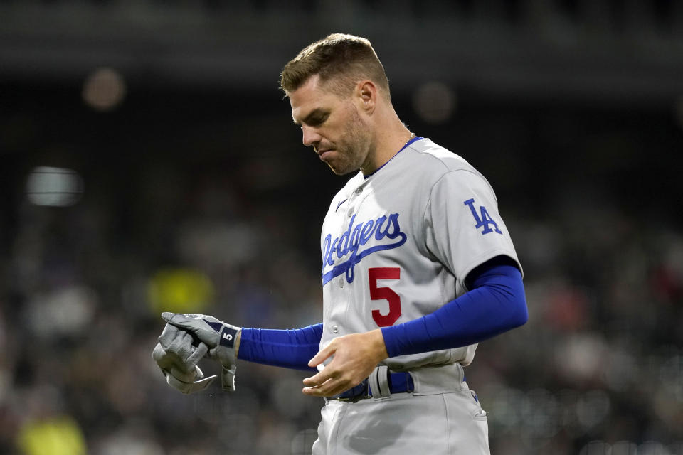 Los Angeles Dodgers' Freddie Freeman pulls off his batting gloves after flying out to end the top of the sixth inning of the team's baseball game against the Chicago White Sox on Tuesday, June 7, 2022, in Chicago. (AP Photo/Charles Rex Arbogast)