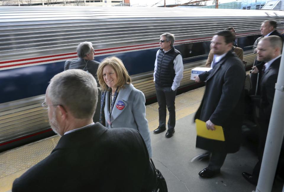 Some of the 1,000 lobbyists, business owners and politicians gather on a platform at the Trenton train station as a train arrives to take them to Washington, D.C., Thursday, Feb. 16, 2017, in Trenton, N.J. The state Chamber of Commerce's 80th annual trip — nicknamed the "Walk to Washington" because rail riders generally pace the train's corridors schmoozing and handing out business cards — comes after a national election that hinged in part on repudiating insiders and establishment politics. (AP Photo/Mel Evans)