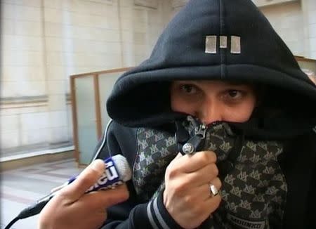 A man identified by a lawyer as Cherif Kouachi, one of the two brothers who killed 12 people in the attack on the weekly paper Charlie Hebdo in Paris, is seen in this still image taken from Reuters TV video shot at a Paris courthouse while facing charges of helping smuggle Islamist fighters into Iraq, March 19, 2008. REUTERS/Reuters Tv