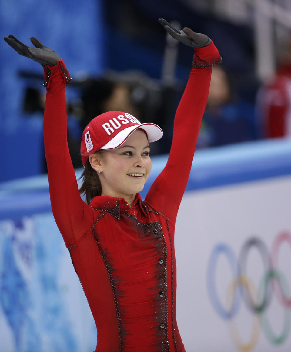 Julia Lipnitskaia of Russia waves to spectators after competing in the women's team free skate figure skating competition at the Iceberg Skating Palace during the 2014 Winter Olympics, Sunday, Feb. 9, 2014, in Sochi, Russia. (AP Photo/David J. Phillip)