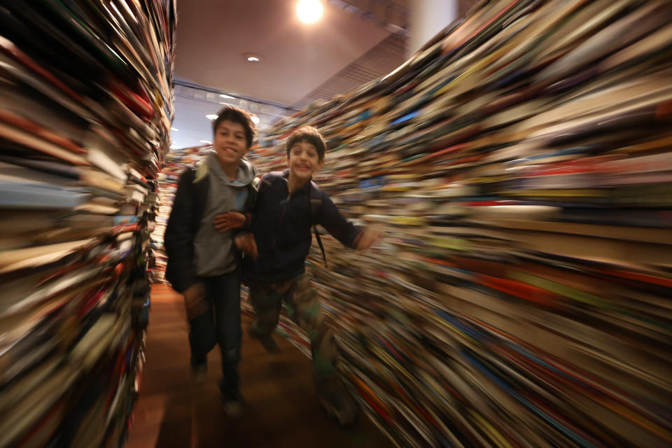 Children run in the 'aMAZEme' labyrinth made from books at The Southbank Centre on July 31, 2012 in London, England. (Photo by Peter Macdiarmid/Getty Images)