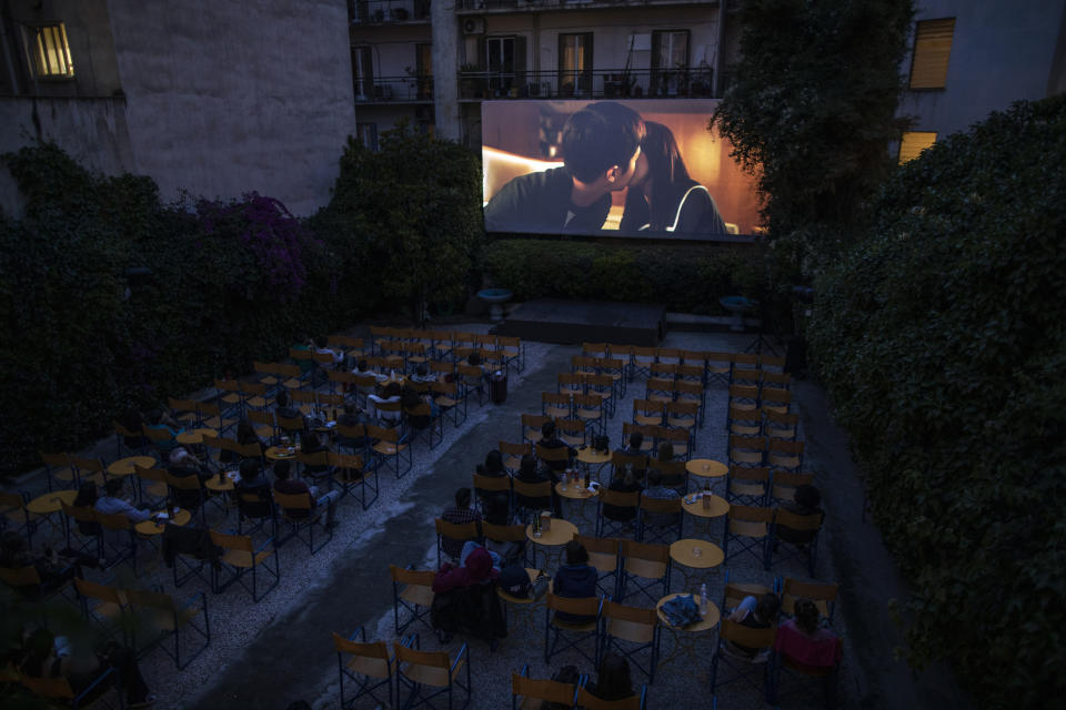 In this Wednesday, June 3, 2020 photo moviegoers watch the 2019 South Korean black comedy film Parasite at the Panathinea outdoor cinema in Neapoli, central Athens. (AP Photo/Petros Giannakouris)