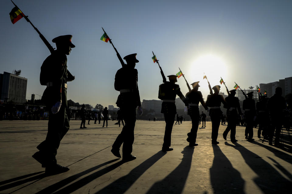 Ethiopian military parade with national flags attached to their rifles at a rally organized by local authorities to show support for the Ethiopian National Defense Force (ENDF), at Meskel square in downtown Addis Ababa, Ethiopia Sunday, Nov. 7, 2021. (AP Photo)