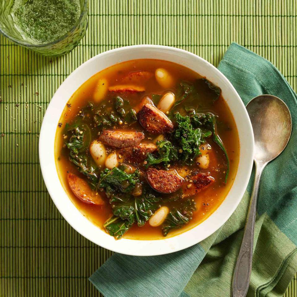 <p>This quick soup recipe is done in only 15 minutes thanks to convenience products like frozen chopped onion and precooked kielbasa. You'll have a warming winter soup on the table in no time! <a href="https://www.eatingwell.com/recipe/7883745/white-bean-kale-kielbasa-soup/" rel="nofollow noopener" target="_blank" data-ylk="slk:View Recipe;elm:context_link;itc:0;sec:content-canvas" class="link ">View Recipe</a></p>