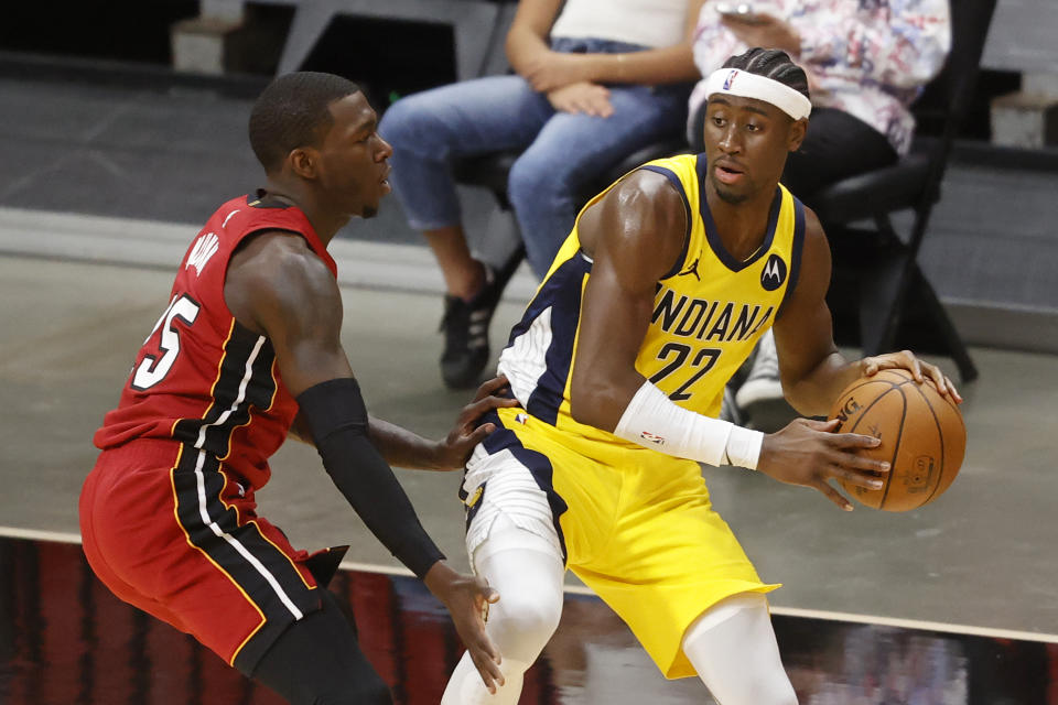 Miami Heat guard Kendrick Nunn (25) defends against Indiana Pacers guard Caris LeVert (22) during the second half of an NBA basketball game Friday, March 19, 2021, in Miami. (AP Photo/Joel Auerbach)