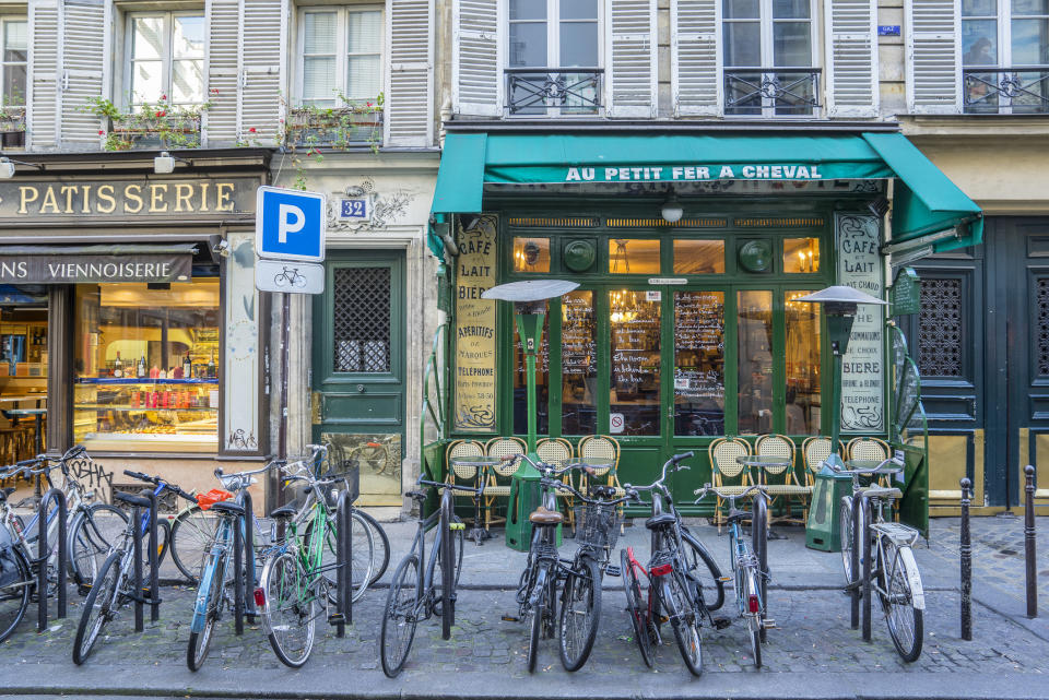 Bikes parked outside stores in Paris.