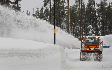 FILE PHOTO: Snow is cleared from the Donner Pass rest area at Donner Pass summit during a winter storm, near Truckee, California, U.S. January 7, 2017. REUTERS/Bob Strong/File Photo
