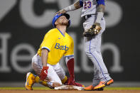 Boston Red Sox catcher Christian Vazquez, left, gets a congratulatory pat on the head by New York Mets second baseman Javier Baez (23) after his RBI double in the fourth inning of a baseball game at Fenway Park, Tuesday, Sept. 21, 2021, in Boston. (AP Photo/Charles Krupa)