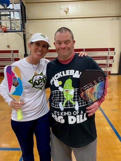 Greenville Special Olympics Golf and Pickleball Coach Sandy Halkett is pictured having fun with students from her teams.