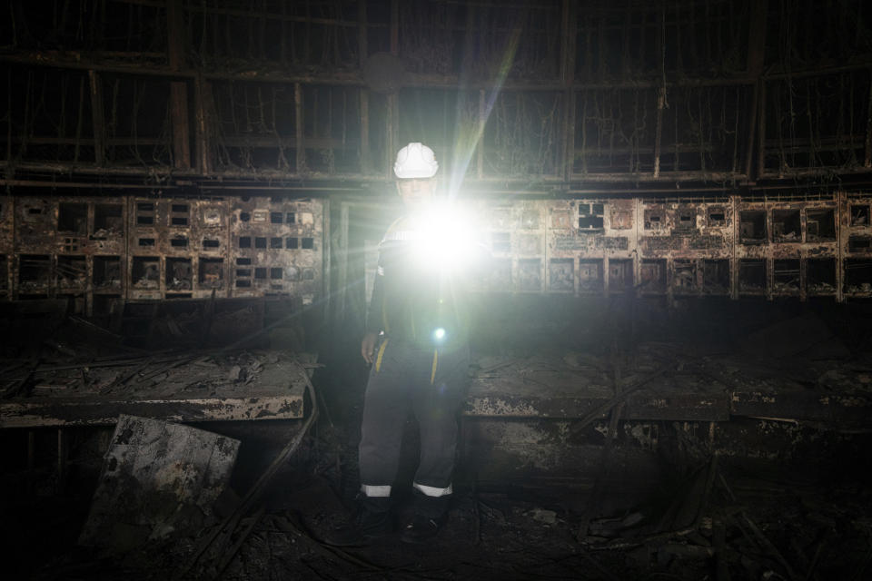 Engineer Oleksandr lights the operating room which was destroyed by a Russian missile attack at DTEK's power plant in Ukraine, on Tuesday, April 2, 2024. Russia is attacking Ukraine’s energy sector with renewed intensity and alarming accuracy, signaling to Ukrainian officials that Russia is armed with better intelligence and fresh tactics in its campaign to annihilate the country’s power generation capacity. (AP Photo/Evgeniy Maloletka)