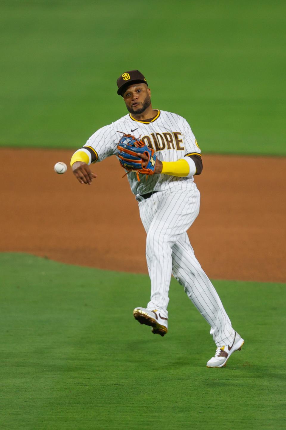 San Diego Padres second baseman Robinson Cano makes the throw to first base to retire Milwaukee Brewers' Kolten Wong during the seventh inning of a baseball game Monday, May 23, 2022, in San Diego. (AP Photo/Mike McGinnis)