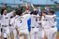 Japan players celebrate a walk-off single hit by Hayato Sakamoto in a baseball game against the Dominican Republic at the 2020 Summer Olympics, Wednesday, July 28, 2021, in Fukushima, Japan. Japan won 4-3. (AP Photo/Jae C. Hong)