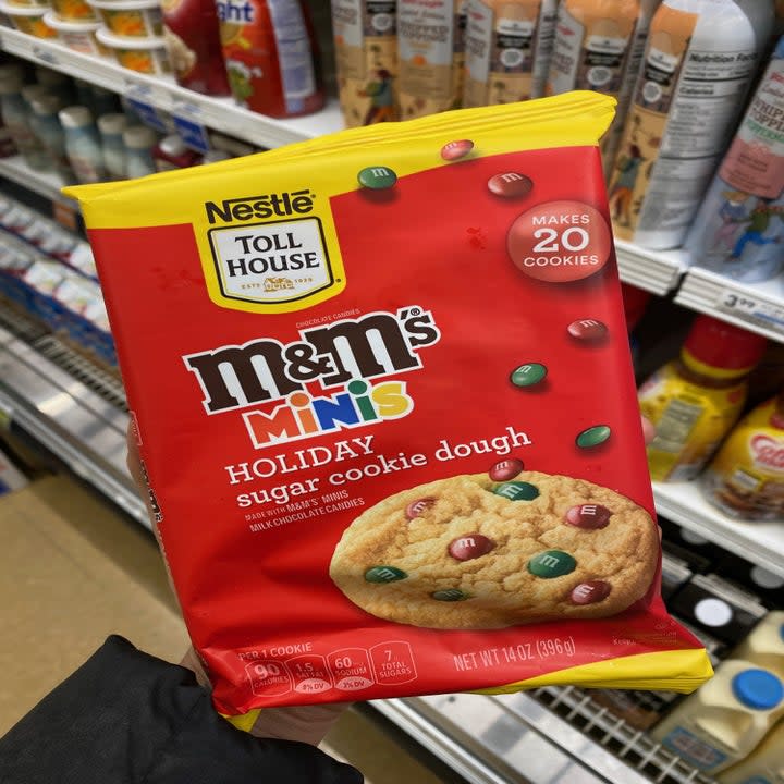 Holding package of M&M's minis holiday cookie dough 