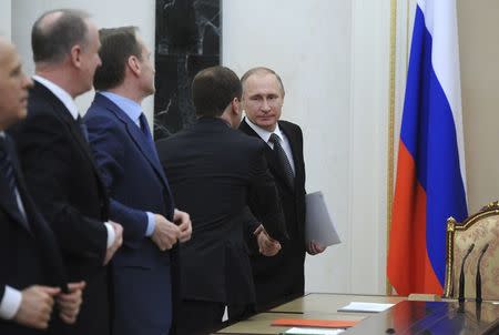 Russian President Vladimir Putin (R) attends a meeting of the Security Council at the Kremlin in Moscow, Russia, April 21, 2016. Mikhail Klimentyev/Sputnik/Kremlin via Reuters