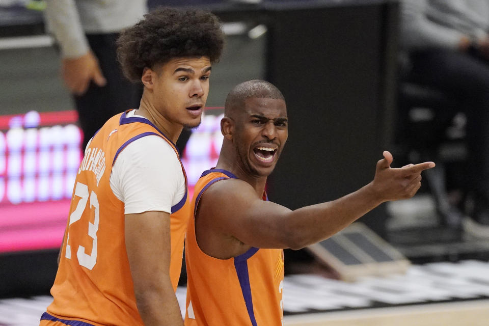 Phoenix Suns guard Chris Paul, right, complains to a referee about a call as forward Cameron Johnson looks on during the first half in Game 3 of the NBA basketball Western Conference Finals against the Los Angeles Clippers Thursday, June 24, 2021, in Los Angeles. (AP Photo/Mark J. Terrill)