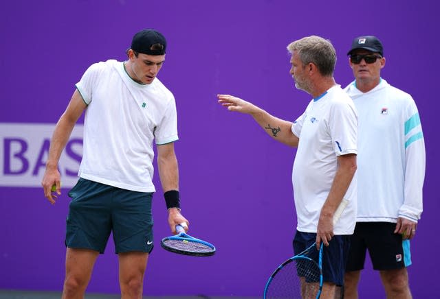 Jack Draper, left, talks to coach James Trotman while Wayne Ferreira, in the background, watches