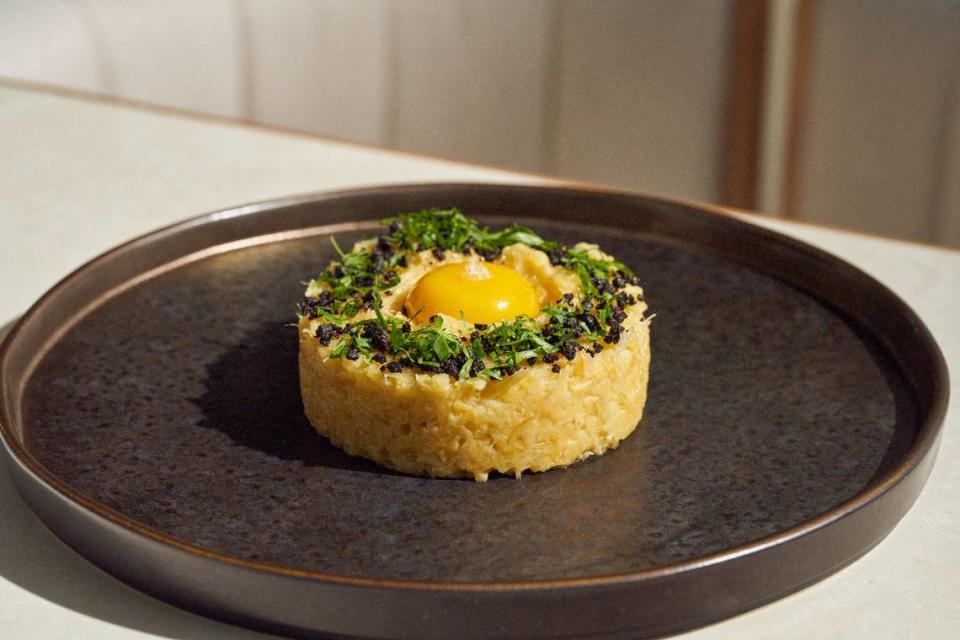 The signature dish bacalau a brás from Chef Henrique Sá Pessoa is a traditional Portuguese favorite with salted cod, fried string potatoes and an egg yolk.