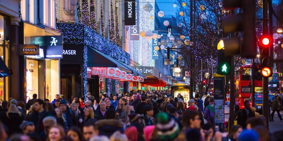 Christmas lights decoration at Oxford street and lots of people walking during the Christmas sale