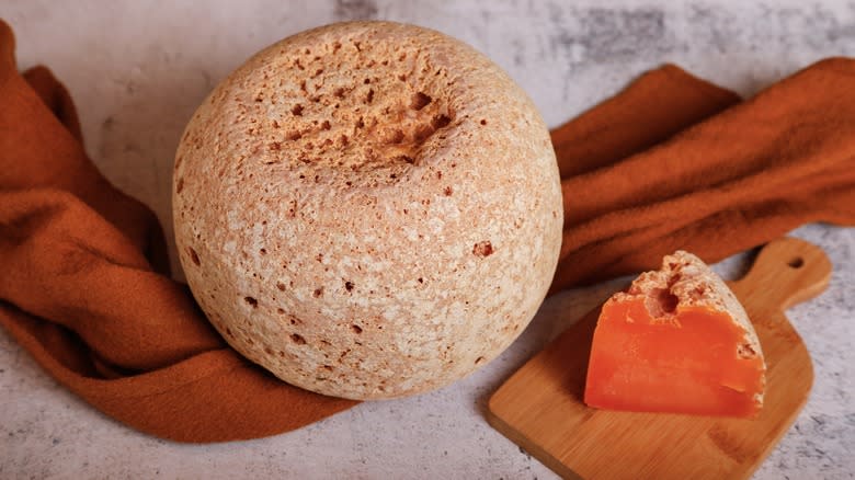 whole mimolette and a slice 