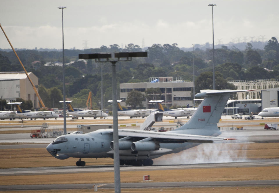 In this photo released by China's Xinhua news agency, a Chinese IL-76 plane searching for the missing Malaysia Airlines Flight MH370 lands at Perth airport, Australia, after a hunting sortie Monday, March 24, 2014. A Chinese plane on Monday spotted two white, square-shaped objects in an area identified by satellite imagery as containing possible debris from the missing Malaysian airliner, while the United States separately prepared to send a specialized device that can locate black boxes. The crew aboard an IL-76 plane sighted the object in the southern Indian Ocean and reported the coordinates to the Australian command center, which is coordinating the multinational search, as well as the Chinese icebreaker Snow Dragon, which is en route to the area, China's Xinhua News Agency reported. (AP Photo/Xinhua, Lui Siu Wai) NO SALES