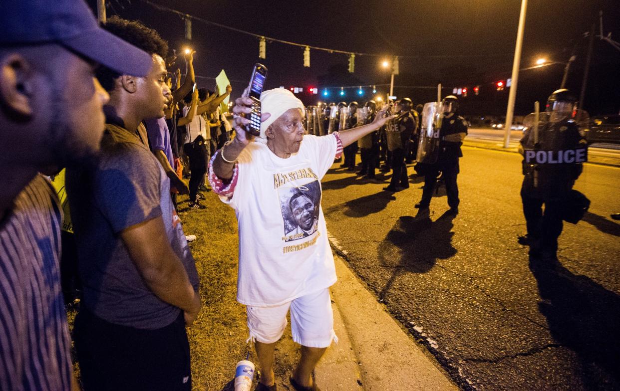 BATON ROUGE, LA -JULY 10: People gather to protest the shooting of Alton Sterling on July 10, 2016 in Baton Rouge, Louisiana. Alton Sterling was shot by a police officer in front of the Triple S Food Mart in Baton Rouge on July 5th, leading the Department of Justice to open a civil rights investigation. (Photo by Mark Wallheiser/Getty Images)