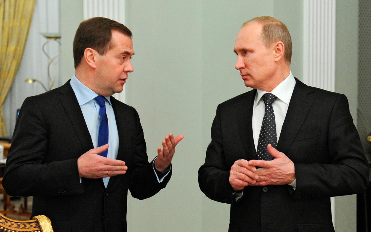 Russian President Vladimir Putin, right, and Dmitry Medvedev, the ex Russian president - Mikhail Klimentyev/AP