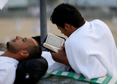 A Muslim pilgrim reads the Koran on Mount Mercy on the plains of Arafat during the annual haj pilgrimage, outside the holy city of Mecca, Saudi Arabia September 11, 2016. REUTERS/Ahmed Jadallah