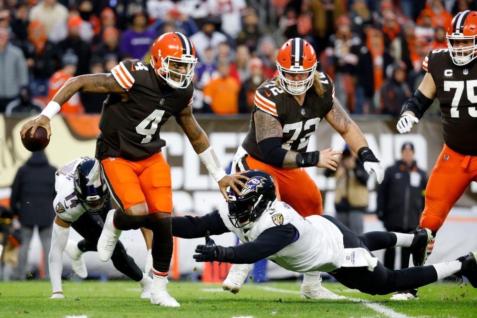 Cleveland Browns quarterback Deshaun Watson breaks a tackle by Baltimore Ravens linebacker Jason Pierre-Paul.