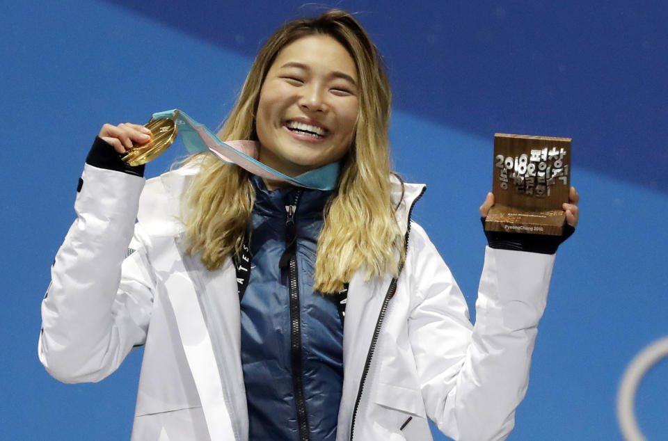 FILE - In this Feb. 13, 2018, file photo, women's halfpipe gold medalist Chloe Kim, of the United States, poses during the medals ceremony at the 2018 Winter Olympics in Pyeongchang, South Korea. Heading to Princeton next fall, Kim is trading her board for books as she tries to blend in and become your normal college freshman. (AP Photo/Morry Gash, File)