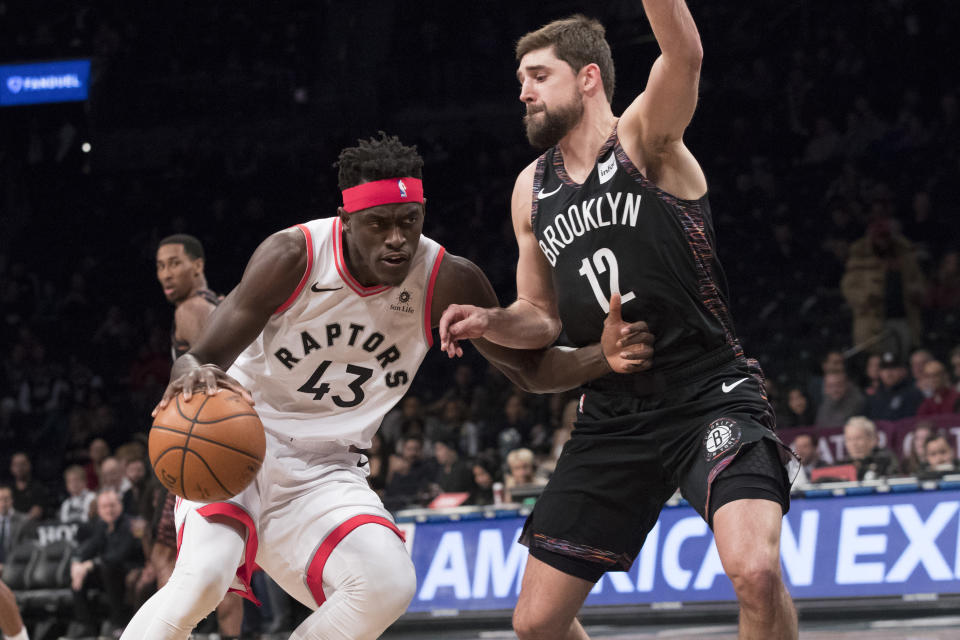 Toronto Raptors forward Pascal Siakam (43) drives to the basket against Brooklyn Nets forward Joe Harris (12) during the first half of an NBA basketball game, Friday, Dec. 7, 2018, in New York. (AP Photo/Mary Altaffer)