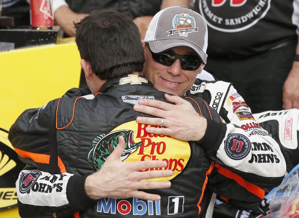 Kevin Harvick, right, gets a hug from Tony Stewart after Harvick woin the NASCAR Sprint Cup Series auto race Sunday, March 2, 2014, in Avondale, Ariz. (AP Photo/Ross D. Franklin)