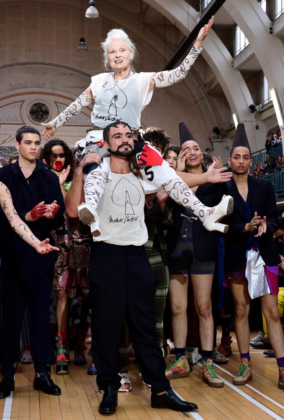 <p>Vivienne Westwood rides a model’s shoulders during her SS18 show.<br><i>[Photo: PA]</i> </p>