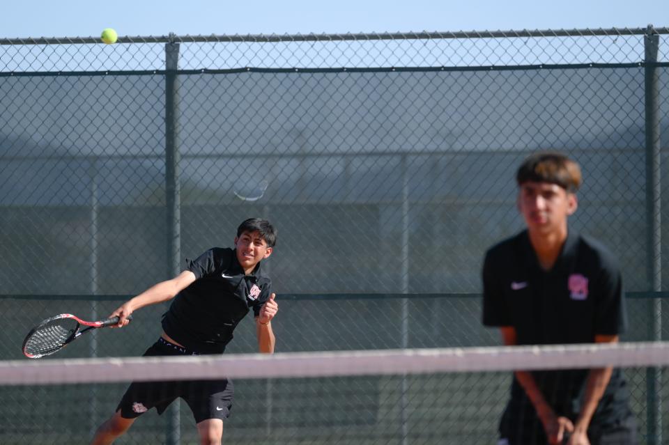 Oak Hill's Herman Velasco, left, serves the ball and David Gonzalez, right, during their doubles match against Adelanto on Wednesday, May 1, 2024 in Oak Hills. Oak Hills defeated Adelanto in the CIF-Southern Section Division 6 playoffs.
